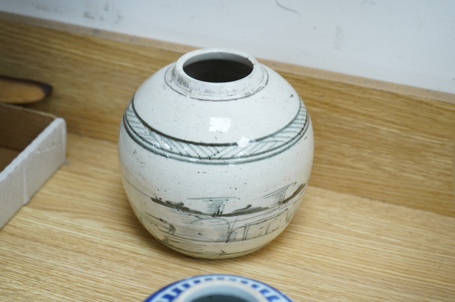 A collection of Chinese pottery jars and a decorated plate, tallest jar 18cm high